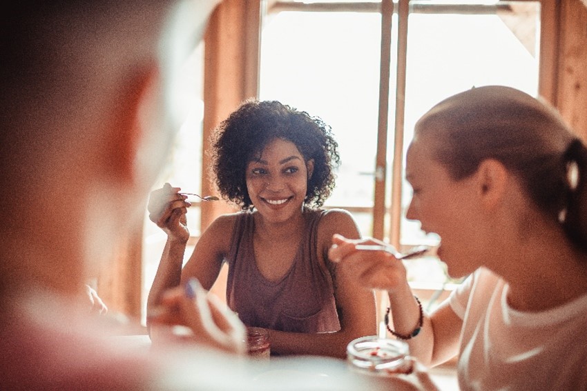 Friends enjoying a meal together and laughing