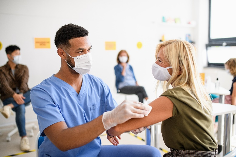 Male doctor giving flu shot to patient