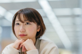 Woman looking forward, pensive look on her face