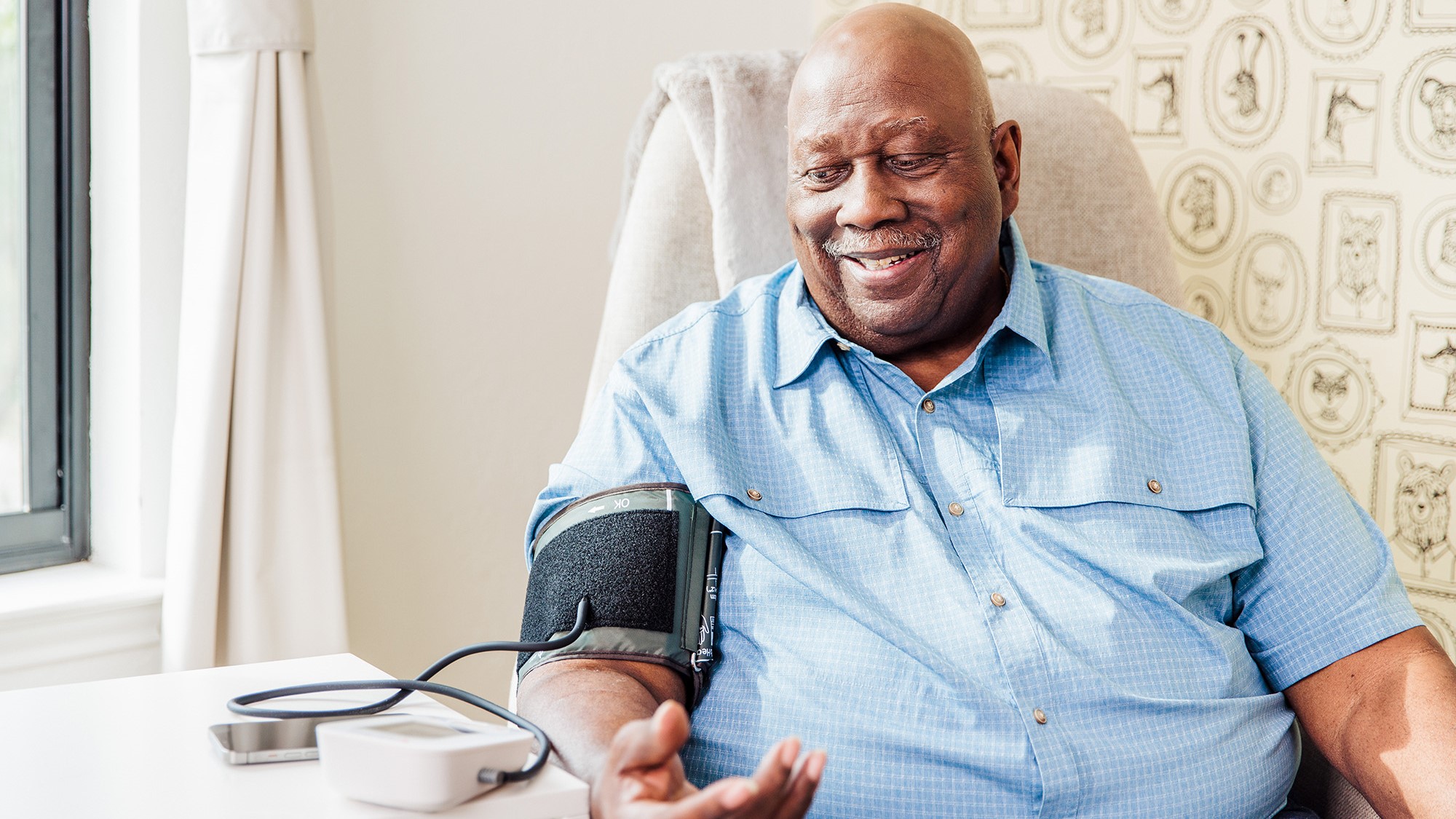 Man using Hello Heart blood pressure monitor