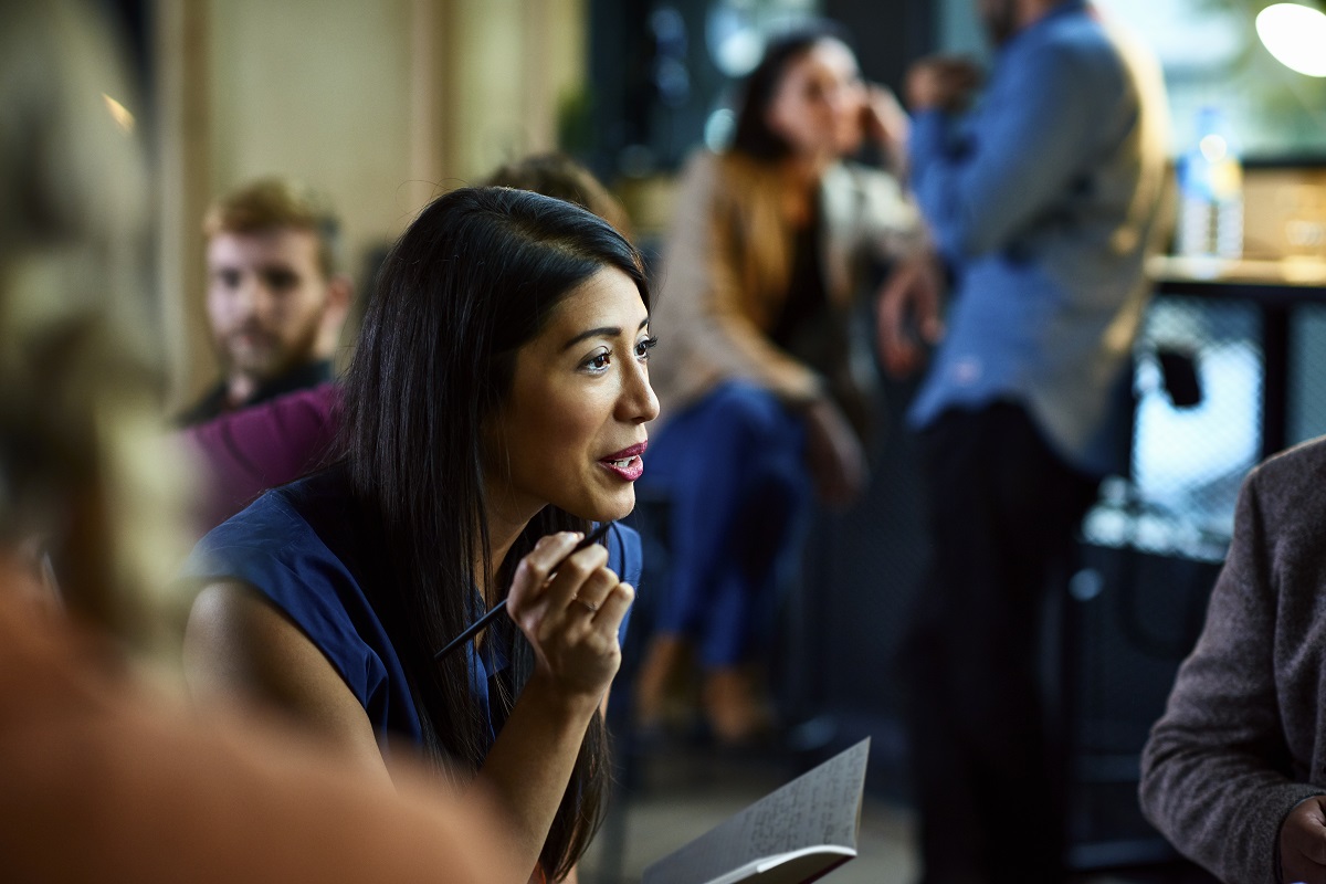 Woman talking to group during meeting