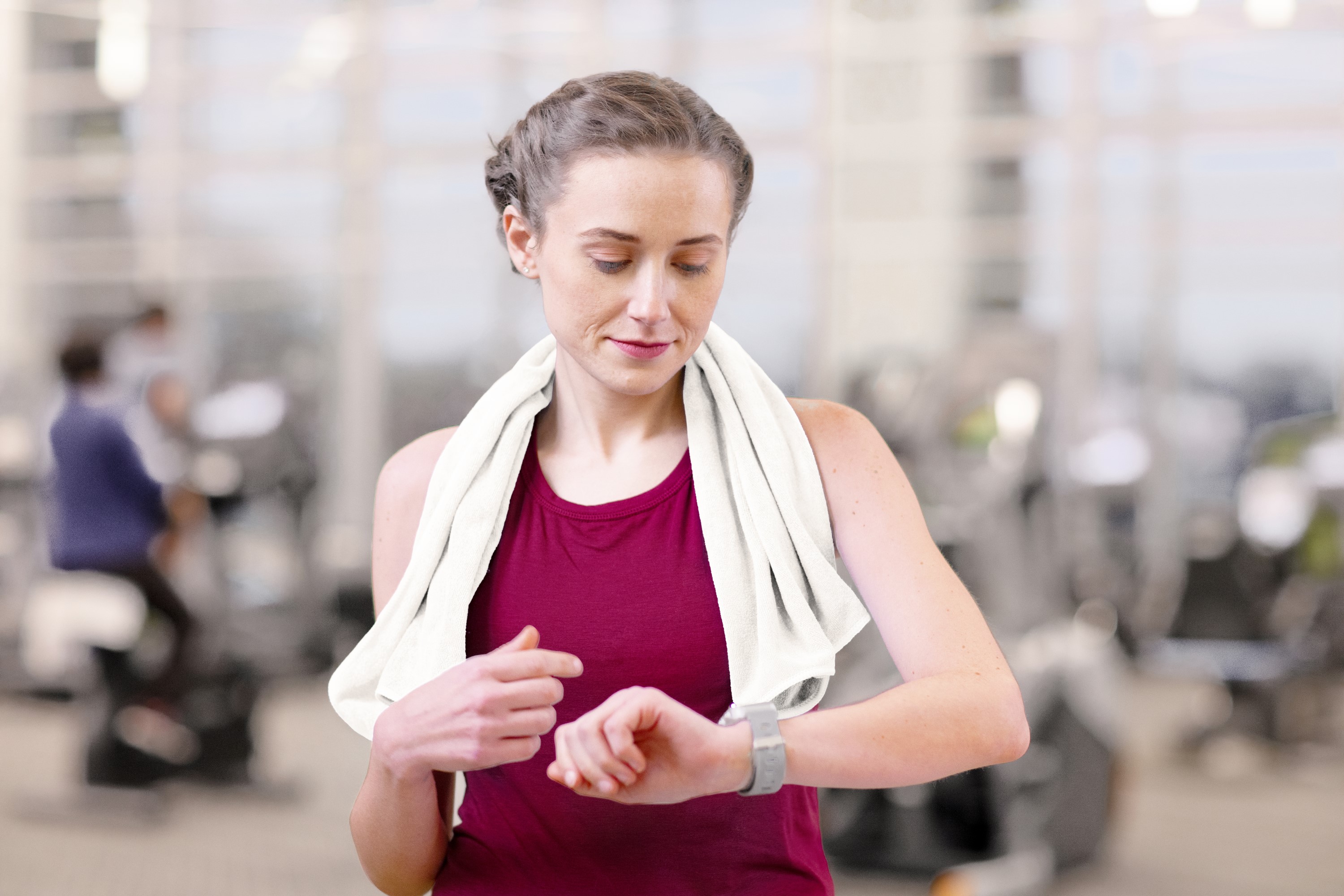 Woman checking her watch at the gym