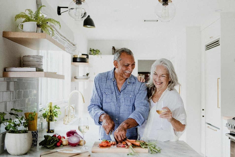 Happy couple chopping vegetables in the kitchen